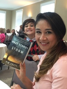 Kim Cross, her son in the background, at the Roswell Reads Literary Luncheon held on March 12.