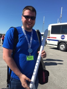 Brandon carrying a model of a Dragon rocket sent to him from a former engineer with SpaceX.
